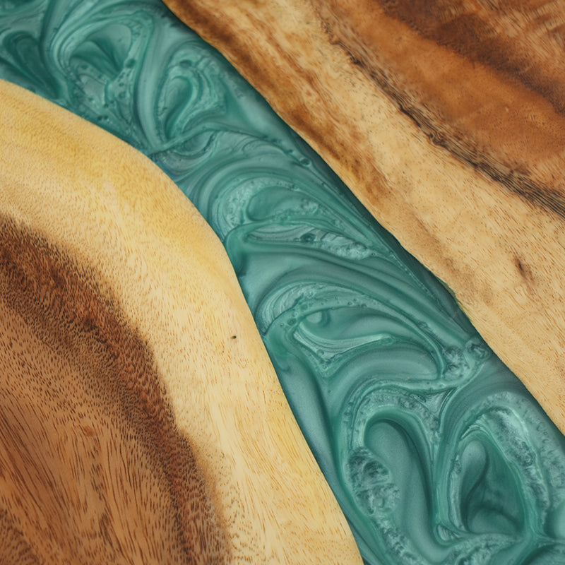 The Custom Green Epoxy Resin River Dining Table is a handcrafted masterpiece featuring agreen epoxy resin river design flowing through a premium natural wood slab. The epoxy resin table top enhances the rich wood tones while providing a high-gloss, long-lasting finish. Ideal as an epoxy resin conference room table or statement dining table, it offers both functionality and artistic appeal. Perfect for modern interiors, this unique epoxy resin wood table brings luxury and craftsmanship into any space.
