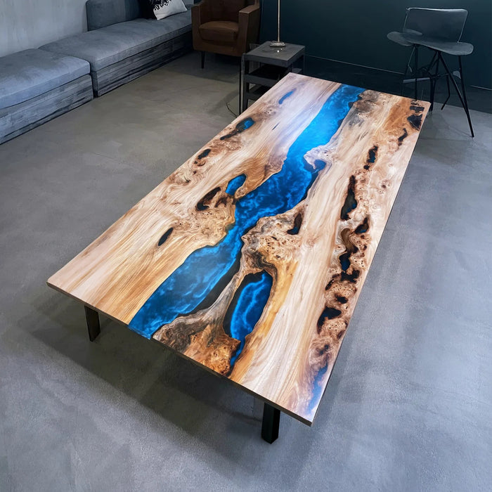 Luxury olive wood river table with flowing deep blue epoxy resin