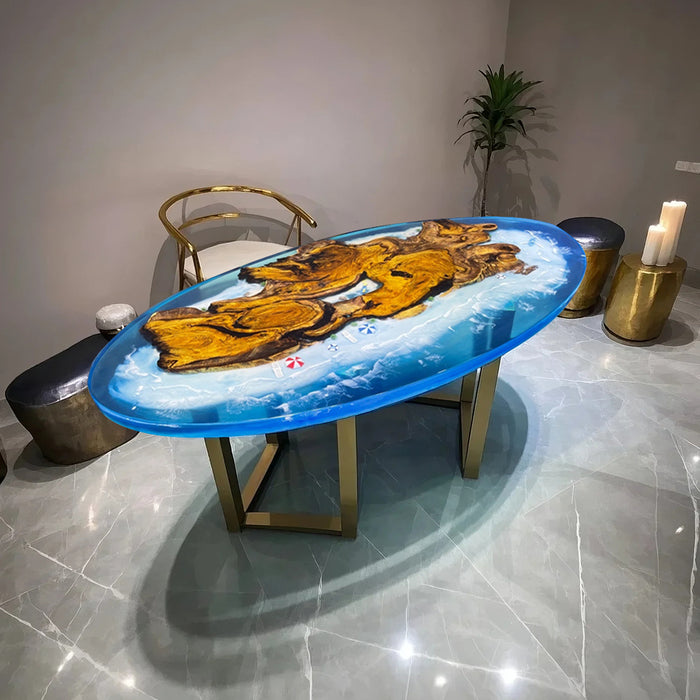 Elegant oval table made from golden camphor wood and ocean blue epoxy resin