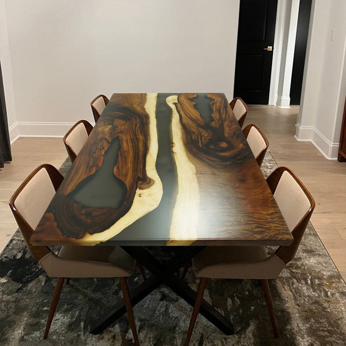 A walnut dining table with a glowing epoxy river.