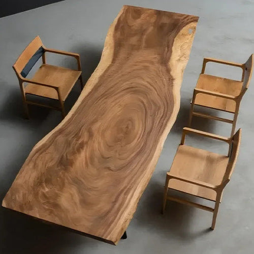 Live edge walnut dining table with natural wood grain pattern, paired with minimalist wooden chairs in a modern, minimal interior.
