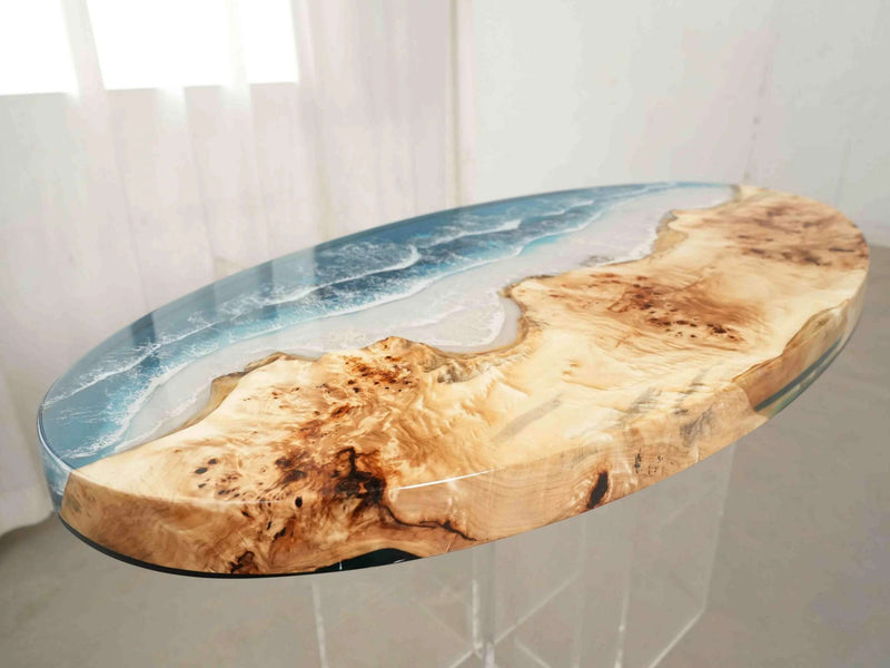 Table with natural wood design and blue resin inlay on a white background