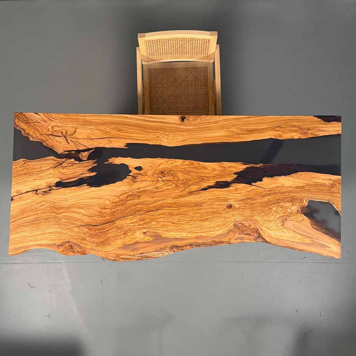 Wooden desk with a wicker chair on a gray background