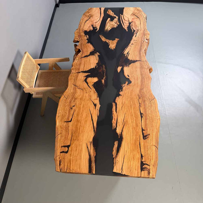 Wooden table with black resin inlay in a minimalistic setting