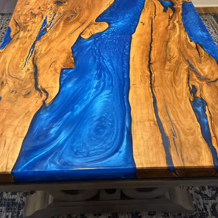Custom blue ocean epoxy dining table with olive wood top