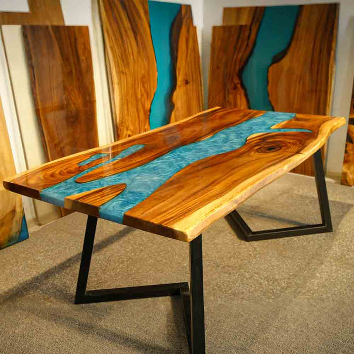 Wooden table with blue resin inlay on a gray floor