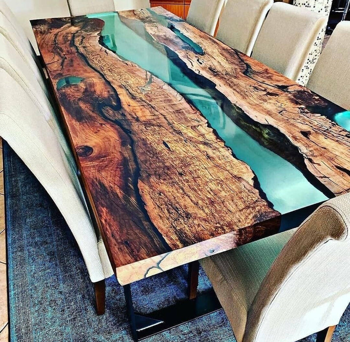 Dining table with a unique design featuring wood and resin in a room setting.