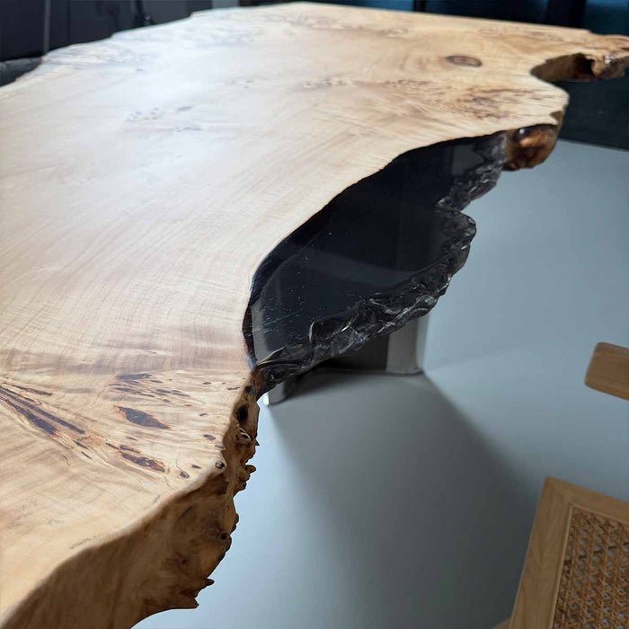 Wooden table with a unique design on a light gray surface