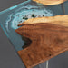 Epoxy ocean walnut table used in reading corner with minimalist chairs