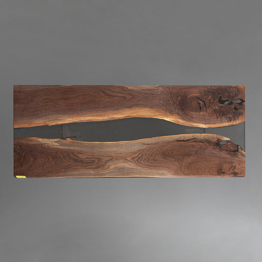 Black walnut epoxy dining table with sleek black resin center, ideal for loft-style dining areas.