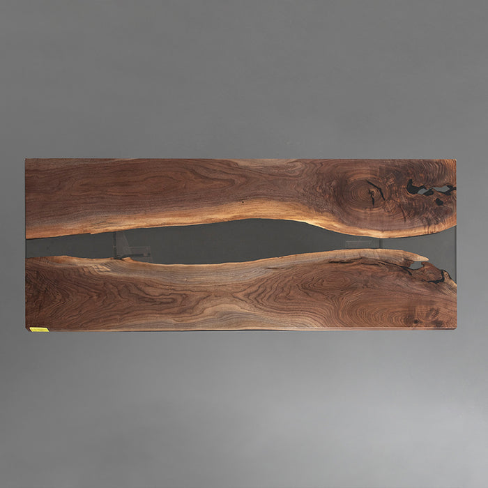 Black walnut epoxy dining table with sleek black resin center, ideal for loft-style dining areas.