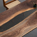 Handcrafted live edge walnut table with black epoxy river, perfect for custom-designed interiors.