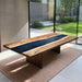 Live edge epoxy river table in a modern dining room with garden view.