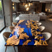 Dining table with blue and gold design in a modern living room