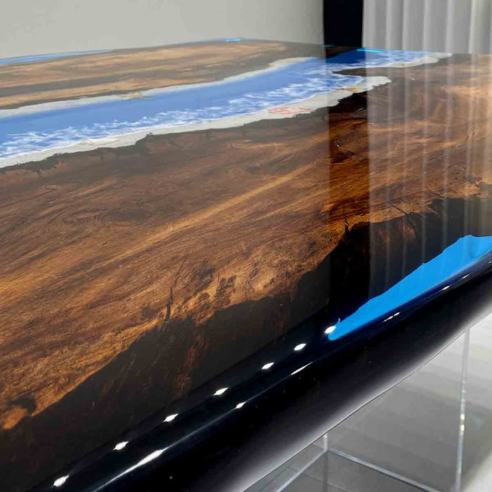 Wooden table with a river design embedded in the surface, featuring blue water and brown land.