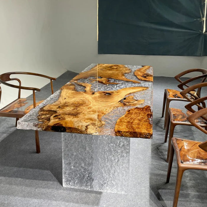 Clear textured epoxy table with natural burl wood slabs and concrete‑style stone base for high‑end home decor