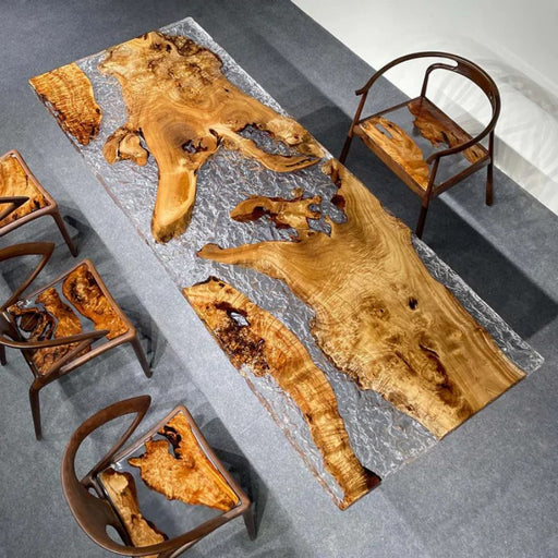 Custom‑made natural burl wood dining table embedded in crystal‑clear textured epoxy resin, heavy stone pillar base plus matching wooden‑epoxy chairs for luxury modern dining room