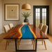 Dining room with a unique wooden table featuring a blue resin inlay.