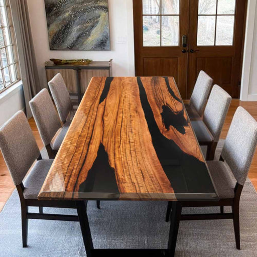 Dining room with a wooden table and chairs in a well-lit room.