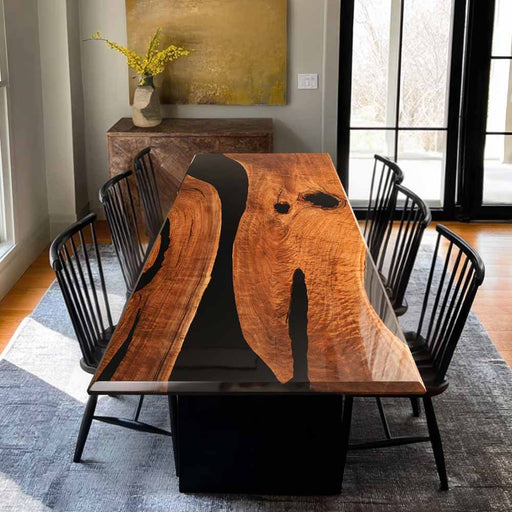 Dining room with a wooden table and black chairs on a gray rug.