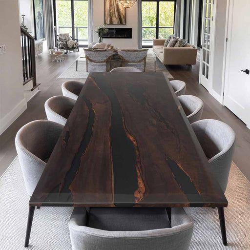 Dining room with a large wooden table and gray chairs in a modern home setting.