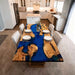 Dining table with blue resin and wood design in a kitchen setting