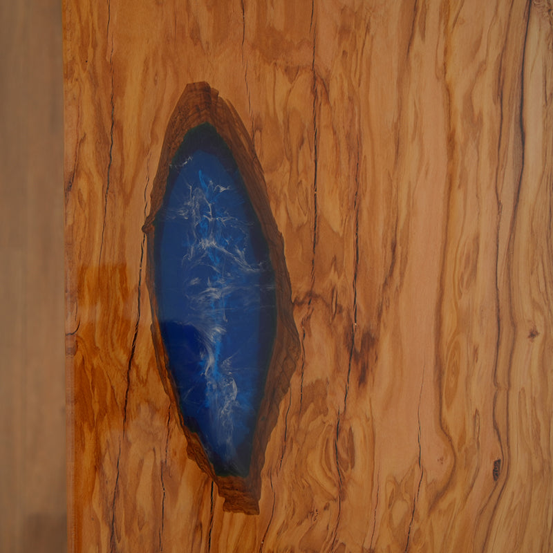 Blue epoxy resin river table with natural wood slab and high-gloss finish