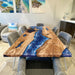 Custom ocean blue epoxy resin dining table with natural wood grain and elegant river design.