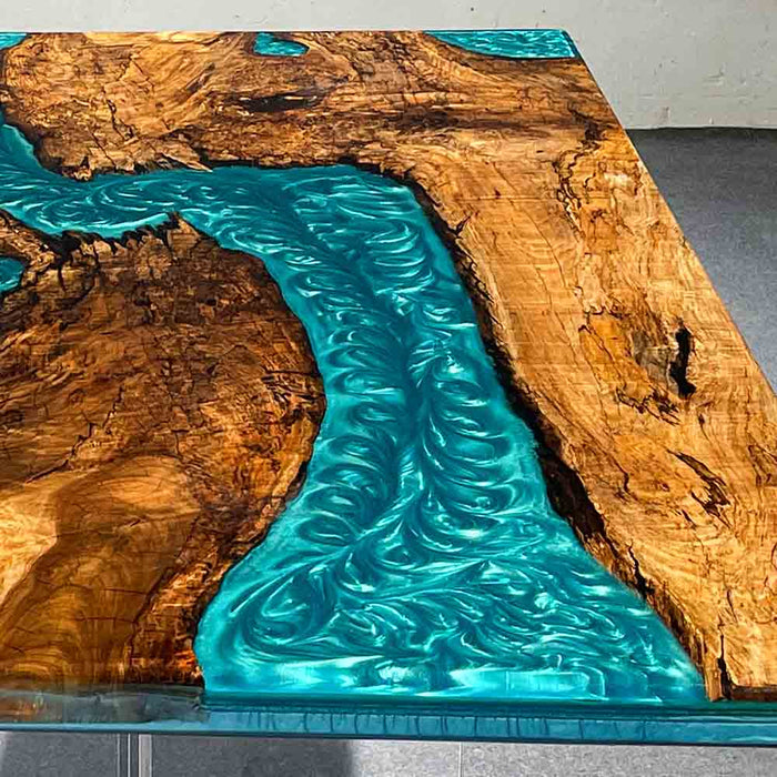Wooden table with blue resin flowing through it