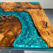 Wooden table with blue resin flowing through it
