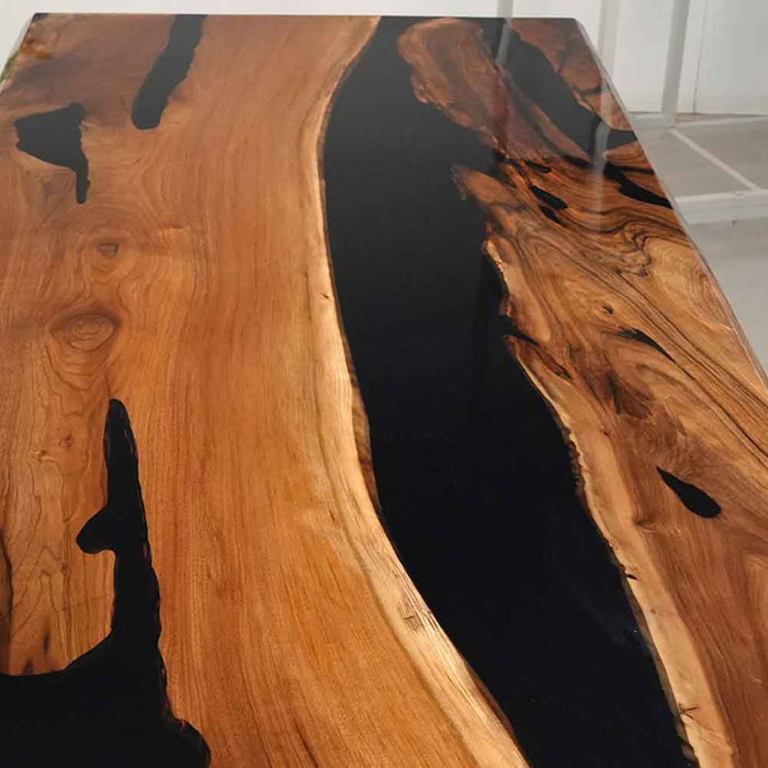 Wooden table with black resin inlay