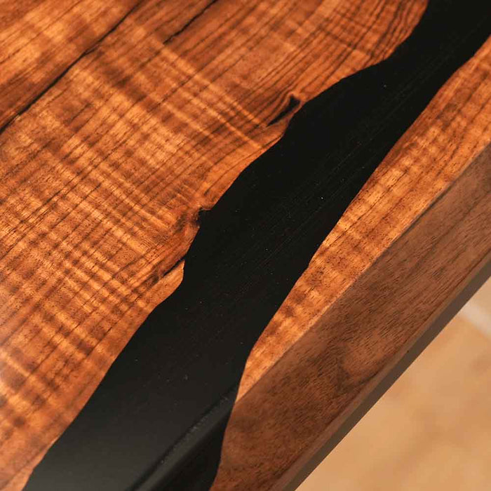 Close-up of a wooden surface with a black strip running through it