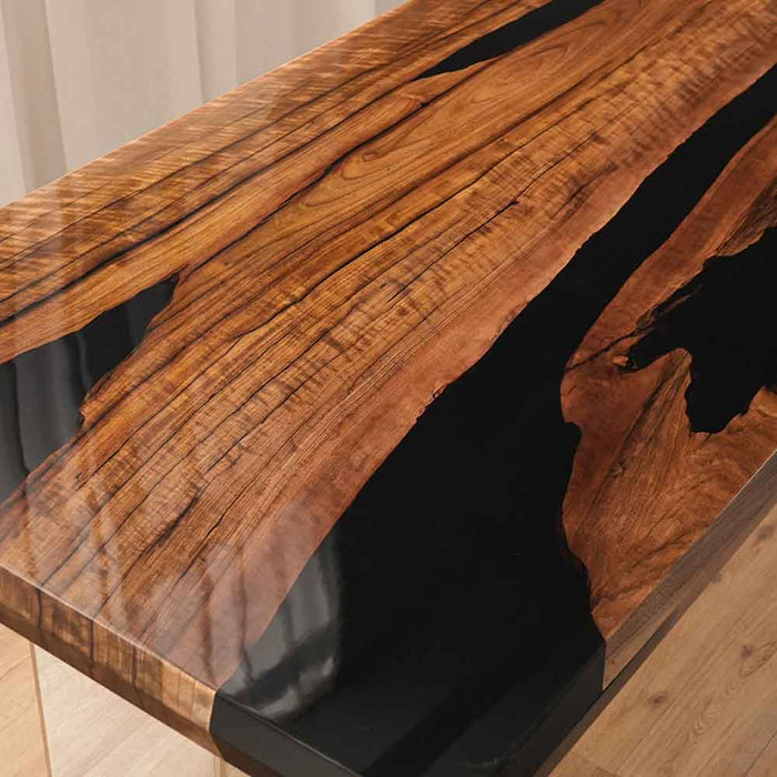 Wooden table with a natural grain pattern and black legs.