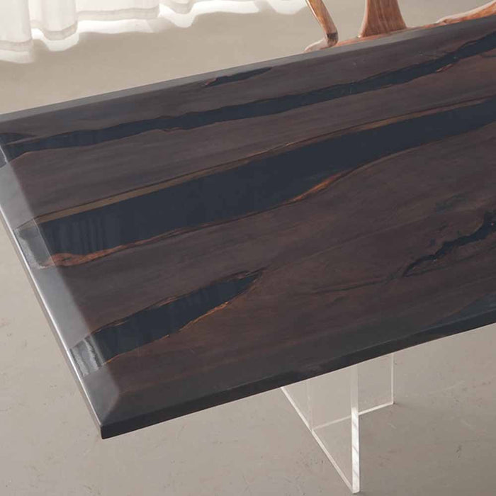 Wooden table with dark finish and clear acrylic legs on a white background