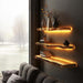 Wooden shelves with LED lighting on a wall next to a window with a view of trees.