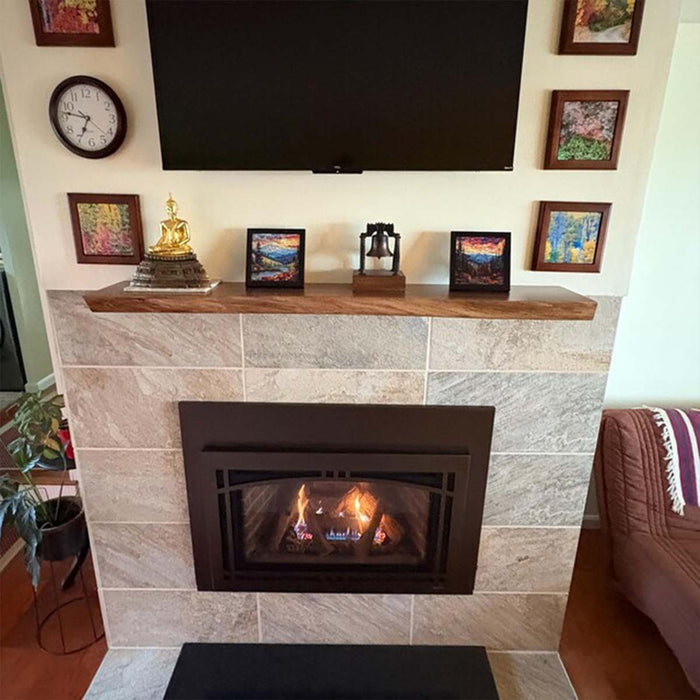 Living room with a fireplace, TV, and decorative items.