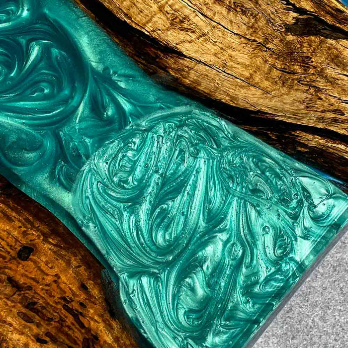 Turquoise marbled soap bar on a wooden surface