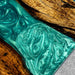 Turquoise marbled soap bar on a wooden surface