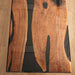 Two wooden cutting boards with a natural grain pattern on a wooden surface.