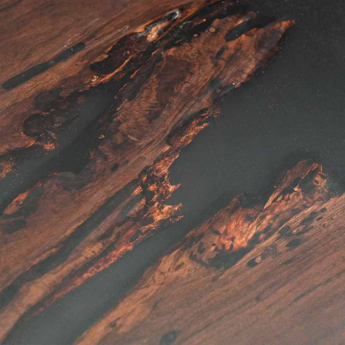 Close-up of a wooden surface with dark brown and black patterns