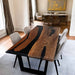 Dining room with a wooden table and chairs in a well-lit room.