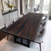 Dining room with a dark wooden table and gray chairs.