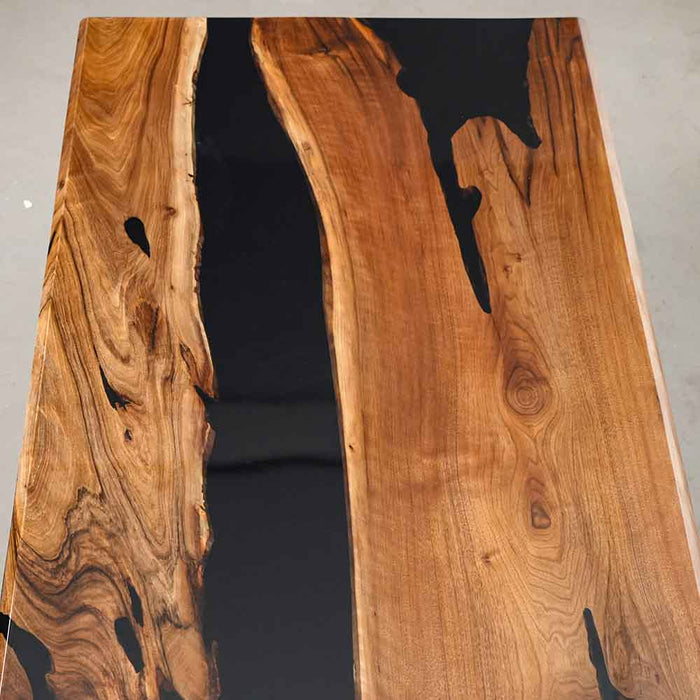 Wooden table with black resin inlay on a gray background