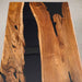 Wooden table with black resin inlay on a gray background
