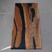 Wooden slab with black resin inlay on a gray surface