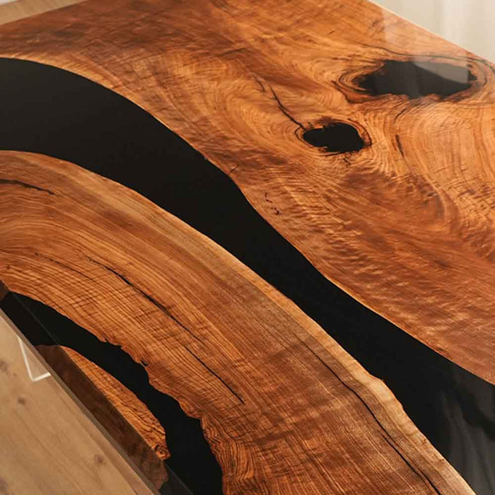 Wooden table with black resin inlay