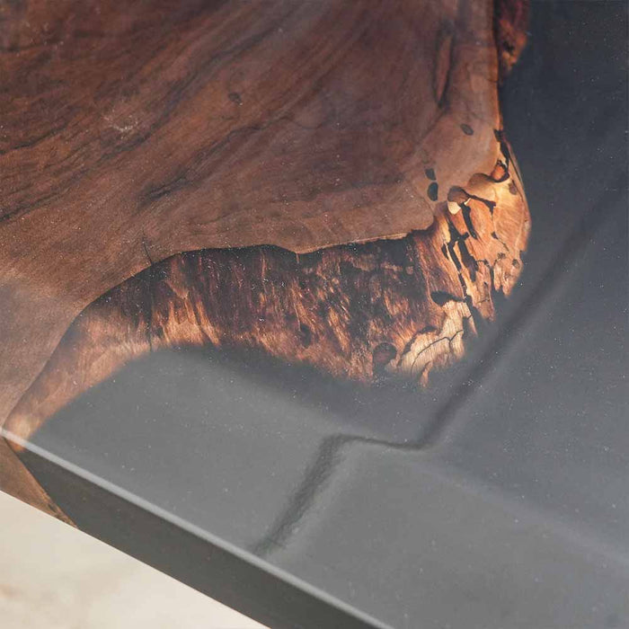 Close-up of a wooden surface with a dark gray concrete base