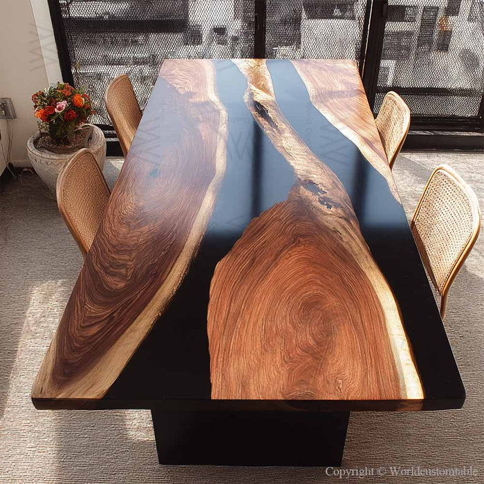 Modern black epoxy resin dining table popular in contemporary Florida interiors.