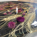 Black walnut epoxy dining table featuring an elegant botanical design sealed in resin.
