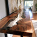 Epoxy console table decorated with vase and lamp in modern entryway